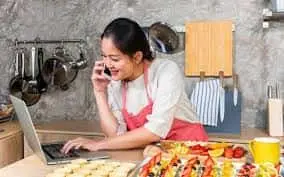 this is  the image of a women running his online business like cloud kitchen and tiffin centre.